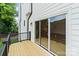Wooden deck showcasing sliding glass doors and black railings, offering serene outdoor living at 129 French St, Charlotte, NC 28216