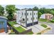 Modern, three-story home featuring a balcony, well-manicured lawn, and a two-car garage at 129 French St, Charlotte, NC 28216