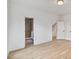 Bright hallway features hardwood floors, neutral walls, and doorway to ensuite bathroom with tiled shower at 129 French St, Charlotte, NC 28216