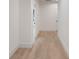 Hallway featuring hardwood floors, fresh white paint, and doors leading to other areas of the home at 129 French St, Charlotte, NC 28216