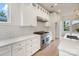 Modern kitchen featuring white cabinets, subway tile backsplash, stainless steel appliances, and quartz countertops at 129 French St, Charlotte, NC 28216
