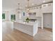 Bright, modern kitchen with white cabinets, stainless steel appliances, and a large center island at 129 French St, Charlotte, NC 28216
