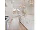 Modern kitchen with a large island, stainless steel appliances, open shelving, and hardwood floors at 129 French St, Charlotte, NC 28216