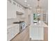 Bright, modern kitchen with white cabinetry, stainless steel appliances, and a large island with quartz countertops at 129 French St, Charlotte, NC 28216
