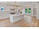 Bright, modern kitchen with white cabinets, stainless steel appliances, and a large center island at 129 French St, Charlotte, NC 28216