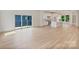 Open floor plan of living room and kitchen with hardwood floors and sliding door to deck at 129 French St, Charlotte, NC 28216