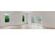 Bright living room featuring hardwood floors, large windows, and sliding glass door to the balcony at 129 French St, Charlotte, NC 28216