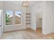 Bright living room with hardwood floors, recessed lighting, a window view, and stylish built-in shelves at 129 French St, Charlotte, NC 28216