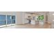 Open floor plan of living room and kitchen with hardwood floors and sliding door to deck at 129 French St, Charlotte, NC 28216
