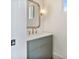 Stylish powder room with a vanity, modern mirror, and decorative light fixture at 129 French St, Charlotte, NC 28216