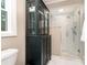 Bathroom showcasing a glass enclosed shower, and decorative display cabinet at 139 Palaside Ne Dr, Concord, NC 28025