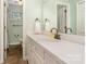 Bright bathroom featuring a white vanity, neutral walls, and a window for natural light at 139 Palaside Ne Dr, Concord, NC 28025