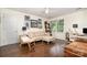 Comfortable bedroom featuring a cozy sitting area, hardwood floors, and a bright window at 139 Palaside Ne Dr, Concord, NC 28025
