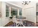 Charming breakfast nook with large windows, hardwood floors, and white wainscoting at 139 Palaside Ne Dr, Concord, NC 28025