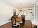 Elegant dining room featuring a wooden table, stylish chairs, a brass chandelier, and built-in storage at 139 Palaside Ne Dr, Concord, NC 28025
