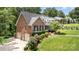 Beautiful brick home with a three-car garage, lush greenery, and well-maintained lawn in a desirable location at 139 Palaside Ne Dr, Concord, NC 28025