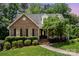 Charming brick home featuring manicured landscaping, a welcoming front door, and a well-maintained lawn at 139 Palaside Ne Dr, Concord, NC 28025
