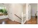 Hallway with hardwood floors, wainscoting, and a view of the window at 139 Palaside Ne Dr, Concord, NC 28025