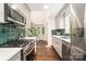 Modern kitchen with stainless steel appliances, green tile backsplash, and a dining nook with natural light at 139 Palaside Ne Dr, Concord, NC 28025