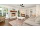 Comfortable living room with white brick fireplace, hardwood floors, natural light, and stylish furniture at 139 Palaside Ne Dr, Concord, NC 28025