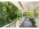 Relaxing back porch overlooking a lush garden, with space for seating and enjoying the outdoors at 139 Palaside Ne Dr, Concord, NC 28025