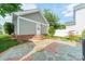 Charming backyard featuring a stone patio, brick accents, and well-maintained landscaping at 14533 Holly Springs Dr, Huntersville, NC 28078