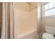 Bright bathroom featuring a tub and shower combo, classic fixtures, and patterned shower curtain at 14533 Holly Springs Dr, Huntersville, NC 28078