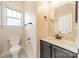 Bright bathroom featuring tile floors, grey cabinets, and marble countertop at 14533 Holly Springs Dr, Huntersville, NC 28078