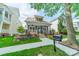 Charming home with covered front porch, stone accents and well-manicured lawn at 14533 Holly Springs Dr, Huntersville, NC 28078
