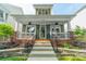 Charming two-story home featuring a covered porch, landscaped front yard, and inviting curb appeal at 14533 Holly Springs Dr, Huntersville, NC 28078
