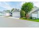 Detached two-car garage with a pristine white door and mature landscaping at 14533 Holly Springs Dr, Huntersville, NC 28078