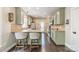 Modern kitchen features neutral green cabinets, stainless steel appliances, granite countertops, and hardwood floors at 14533 Holly Springs Dr, Huntersville, NC 28078