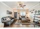 Comfortable living room with hardwood floors, ceiling fan, and a decorative area rug at 14533 Holly Springs Dr, Huntersville, NC 28078
