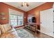 Inviting living room featuring a leather sofa, large window, and a wooden entertainment center at 14533 Holly Springs Dr, Huntersville, NC 28078