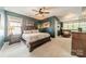 Spacious main bedroom with plush carpeting, a ceiling fan, and ample natural light at 14533 Holly Springs Dr, Huntersville, NC 28078
