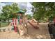 Community playground with colorful play structures and a safe, cushioned surface for children at 14533 Holly Springs Dr, Huntersville, NC 28078