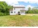 A wide-angle shot of a backyard and a two-story home with white siding and black railing on its back porch at 1471 Marshbrooke Ln, Catawba, NC 28609