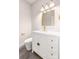 Modern bathroom features a white vanity with gold accents, a decorative mirror, and wood-look floors at 1471 Marshbrooke Ln, Catawba, NC 28609