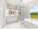 This bright bathroom features double vanity sinks, a standalone tub, and a large glass shower at 1471 Marshbrooke Ln, Catawba, NC 28609