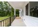 Spacious covered porch with decorative black metal railing and view of lush backyard at 1471 Marshbrooke Ln, Catawba, NC 28609