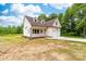 An eye-level view of a charming two-story home with white siding, a covered porch, and an attached garage at 1471 Marshbrooke Ln, Catawba, NC 28609