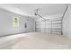 A clean, empty garage with a concrete floor, white walls, and a large garage door at 1471 Marshbrooke Ln, Catawba, NC 28609
