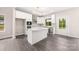 New kitchen features white cabinets, a center island, and stainless steel appliances on gray wood floors at 1471 Marshbrooke Ln, Catawba, NC 28609