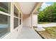 A covered porch with concrete flooring, offering a pleasant outdoor space for relaxation and enjoyment of nature at 1471 Marshbrooke Ln, Catawba, NC 28609