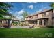 Expansive backyard featuring an outdoor kitchen, patio, and lush lawn, perfect for outdoor entertaining and relaxation at 1500 Lookout Cir, Waxhaw, NC 28173