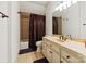 Inviting bathroom featuring a tiled shower, vanity with ample storage, and warm color scheme at 1500 Lookout Cir, Waxhaw, NC 28173