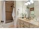 Cozy bathroom featuring a tub, tiled walls, and a stylish vanity with countertop and a decorative mirror at 1500 Lookout Cir, Waxhaw, NC 28173