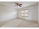 Spacious, bright bedroom features carpet, neutral walls, and crown molding, offering comfort and style at 1500 Lookout Cir, Waxhaw, NC 28173