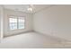 Bright bedroom features a large window, neutral carpet and walls, offering a clean and adaptable space at 1500 Lookout Cir, Waxhaw, NC 28173