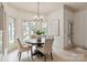 Bright dining area featuring a modern table and chairs beneath a stylish light fixture at 1500 Lookout Cir, Waxhaw, NC 28173